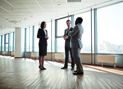 Group of elegant colleagues discussing plans in office