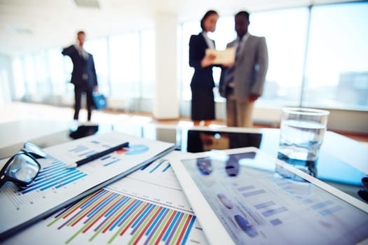 Paper and electronic business documents on desk