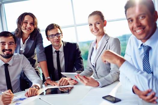 Elegant co-workers looking at camera during meeting in office