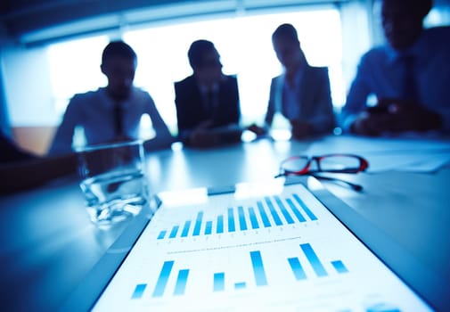 Business document with charts on background of working business team