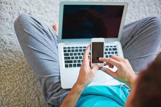 Young man choosing new track from list in cellphone