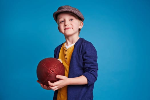 Cute boy with rugby ball