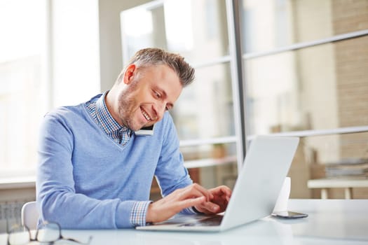 Happy manager typing and phoning