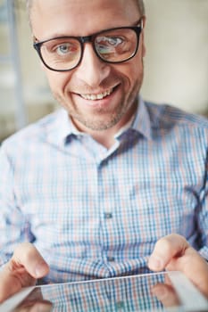 Smiling man with touchpad looking at camera