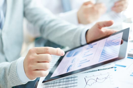 Electronic document in touchpad and hand of businessman pointing at it