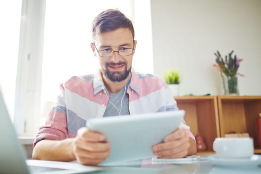 Businessman in casual using digital tablet in office