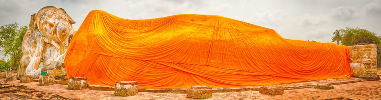 Giant Reclining Buddha in Wat Lokayasutharam. Ayutthaya historical park. Panorama