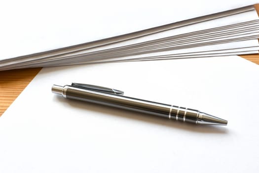 Stationery and ballpoint pens on a desk