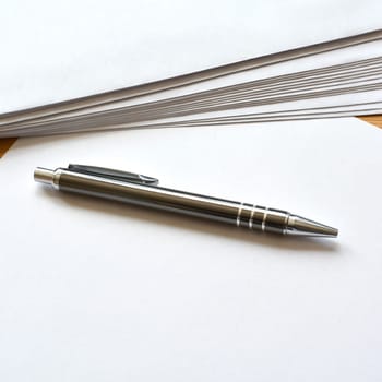 Stationery and ballpoint pens on a desk