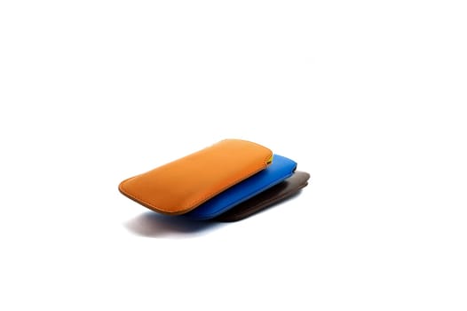 three mobile phones in covers of different color