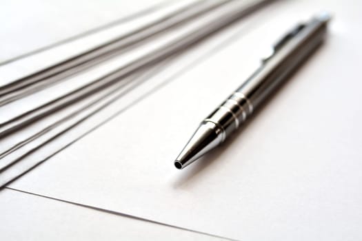 Stationery and ballpoint pens on a desk