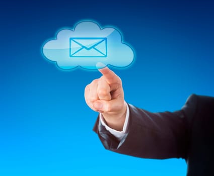 Arm of a corporate person in suit is reaching out to touch a cloud computing symbol containing an email icon. Business metaphor for mobile computing and instant information access. Blue background.