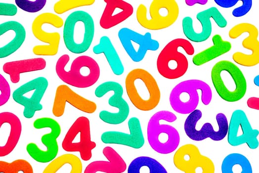 A mix of different single digit numbers from zero to nine, of different bright colours, on a white background.