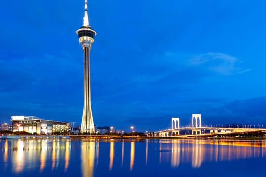 Urban landscape of Macau with famous traveling tower under sky near river in Macao, Asia.
