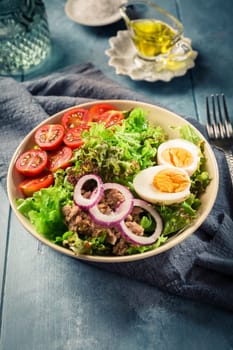 Salad bowl with tuna, egg, tomato and onions - healthy food