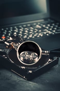 Open Hard drive on keyboard of laptop or notebook in dark tone