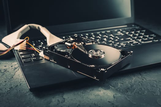 Open Hard drive on keyboard of laptop or notebook in dark tone