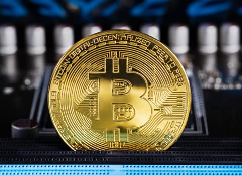 Cryptocurrency bitcoin coins on circuit board. Blockchain technology bitcoin mining concept