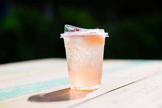 Fresh summer soft drink mocktail pour in recycle Bio plastic glass