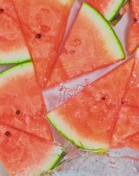 Close up view of the red melon slices in lemonade background. Texture of cooling sweet summer's drink with macro bubbles on the glass wall. Flat design.