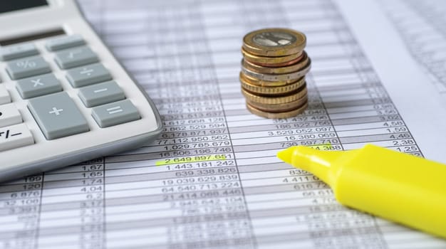 Coins on documents with a calculator