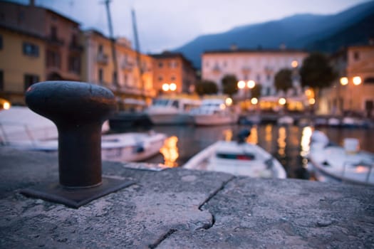 Italian harbour in the evening, small cute village and lighrs in the blurry background