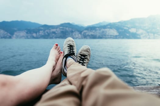 Man with sneakers and barefoot girl are enjoying their holiday evening