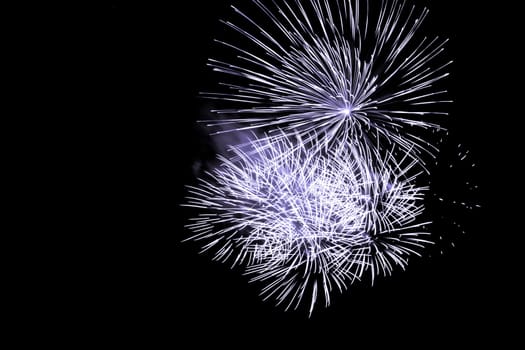 Premium entertainment magic star firework at e.g. New Years Eve or Independence Day party celebration. Black dark night background.