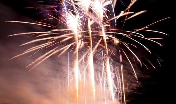 Premium entertainment magic star firework at e.g. New Years Eve or Independence Day party celebration. Black dark night background.