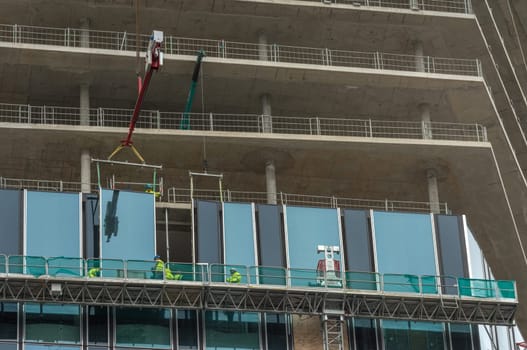 Workers inserting windows on a high-rise building, Frankfurt am Main, Germany