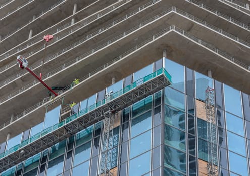 Workers inserting windows on a high-rise building, Frankfurt am Main, Germany