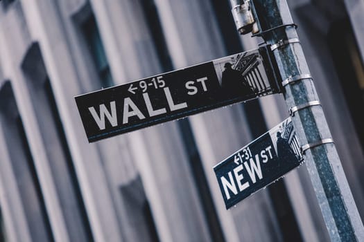 Wall St. street sign in lower Manhattan, New York City, USA.