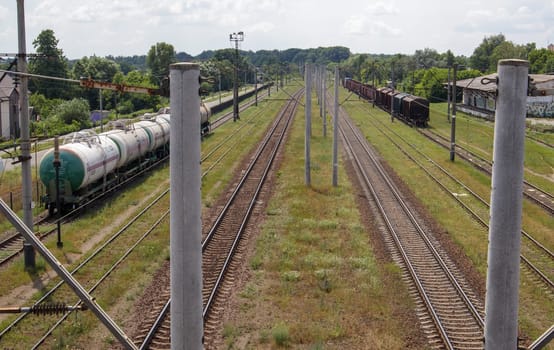 Railway stations with carriages and railroad tracks and trains, transport system. The way forward is the railroad. The modern railway infrastructure was reconstructed