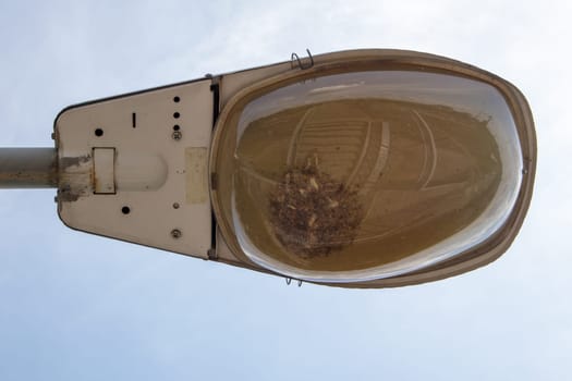 Street lamp close up. Big street lights at a big highway interchange. Close-up. Modern street lamp. Electric old lamp of street lighting on the background of blue sky and clouds during the day