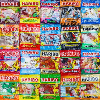 Stuttgart, Germany - March 7, 2021: Haribo gummy bear gummi candy candies different types variety background square in Stuttgart, Germany.