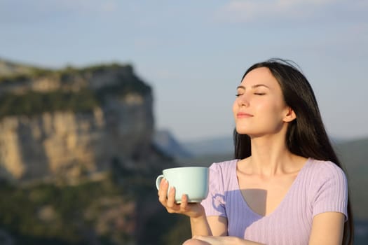 Asian woman drinking coffee relaxing enjoying nature