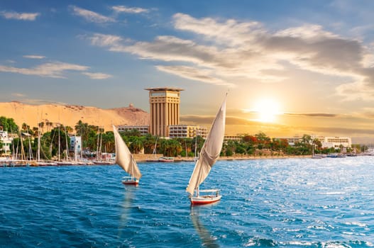 Aswan sunset scenery, view of the Nile and traditional boats, Egypt.