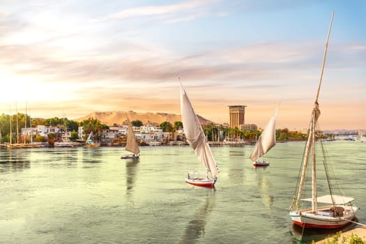 Traditional Nile boats called felucca and river scenery in Aswan, Egypt.