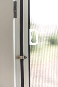 Mosquito net frame on PVC window.