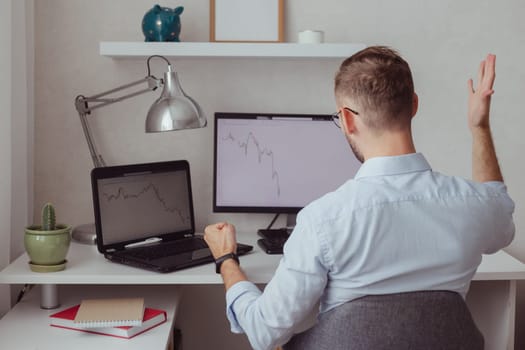 Angry man investor-trader in front of monitors with charts. Stock market correction. Fall of cryptocurrency. Finance failure. Bear market. Forex