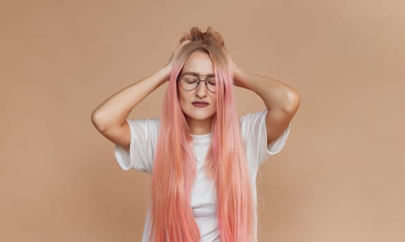 unhappy tired caucasian young woman touching her head and suffering from headache. People, emotions, stress and health care concept