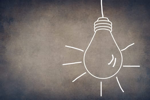A white bulb on a textured background, symbol for idea, creativity, business, planing