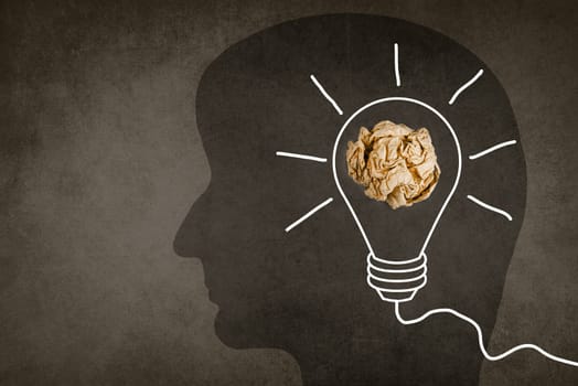 Silhouette of a face with a lightbulb, textured background, empty copy space for text