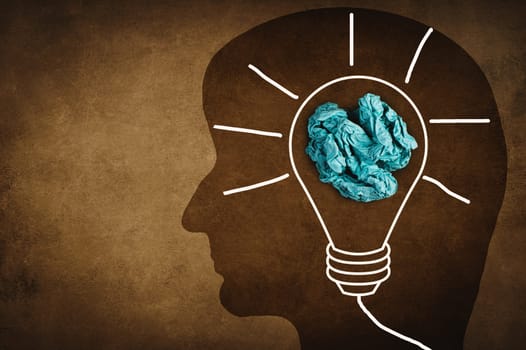 Silhouette of a face with a lightbulb, textured background, empty copy space for text