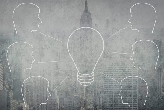 Silhouettes of faces connecting to a light bulb, teamwork, online meeting, communication, city in a blurry background