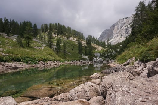 Reflecting water on a small pond on the Seven Lakes Valley Hike, Slovenia 2020