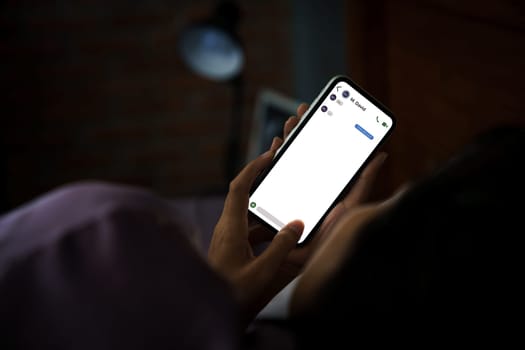 women using phone texting social on bed at night