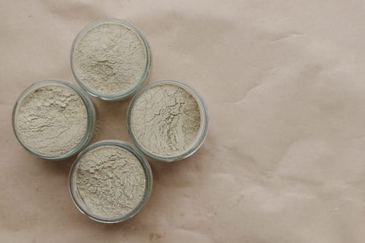 Ayurvedic cosmetic ubtan for face and hair care in glass jars. Vegetable ingredients ground into a powder.