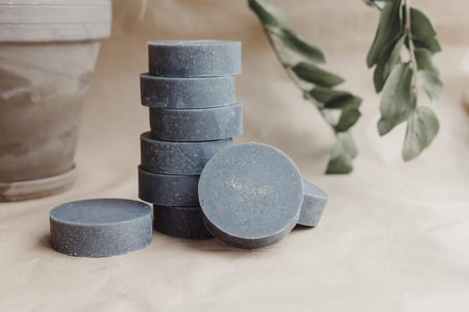 Stack of handmade solid shampoo and conditioner bars on paper background. Copy space for text