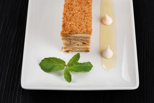 Esterhazy traditional cake with mint on black wooden background